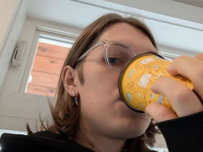 Gen sipping pear lavender matcha latte from moonrise bakery